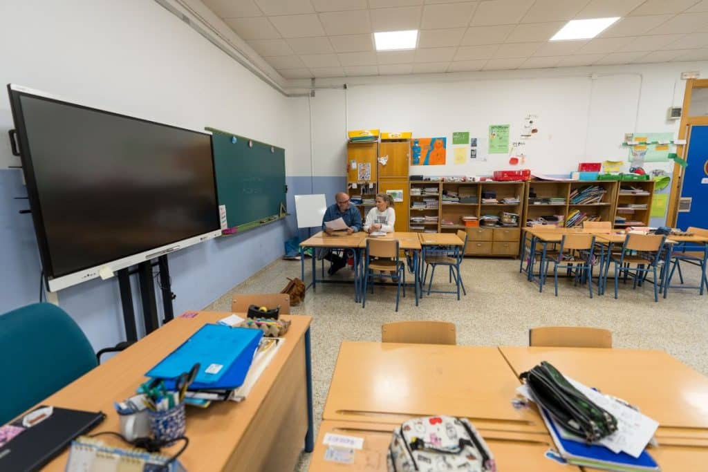 El CEO de APDI Group, Juan Antonio Rosado, y la directora del colegio público Gómez Moreno de Granada, Sara Arteaga, firman la donación de libros a la biblioteca del centro